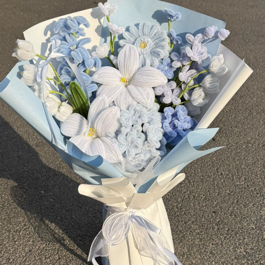 Blue Daydream bouquet detail showing white, pale blue and lilac chenille flowers with folded blue and ivory wrapping.