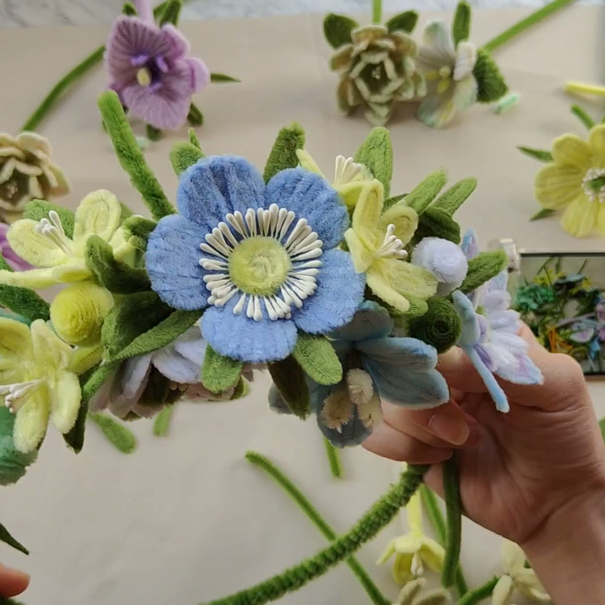 Completed handmade pipe cleaner flower wreath shown in the tutorial