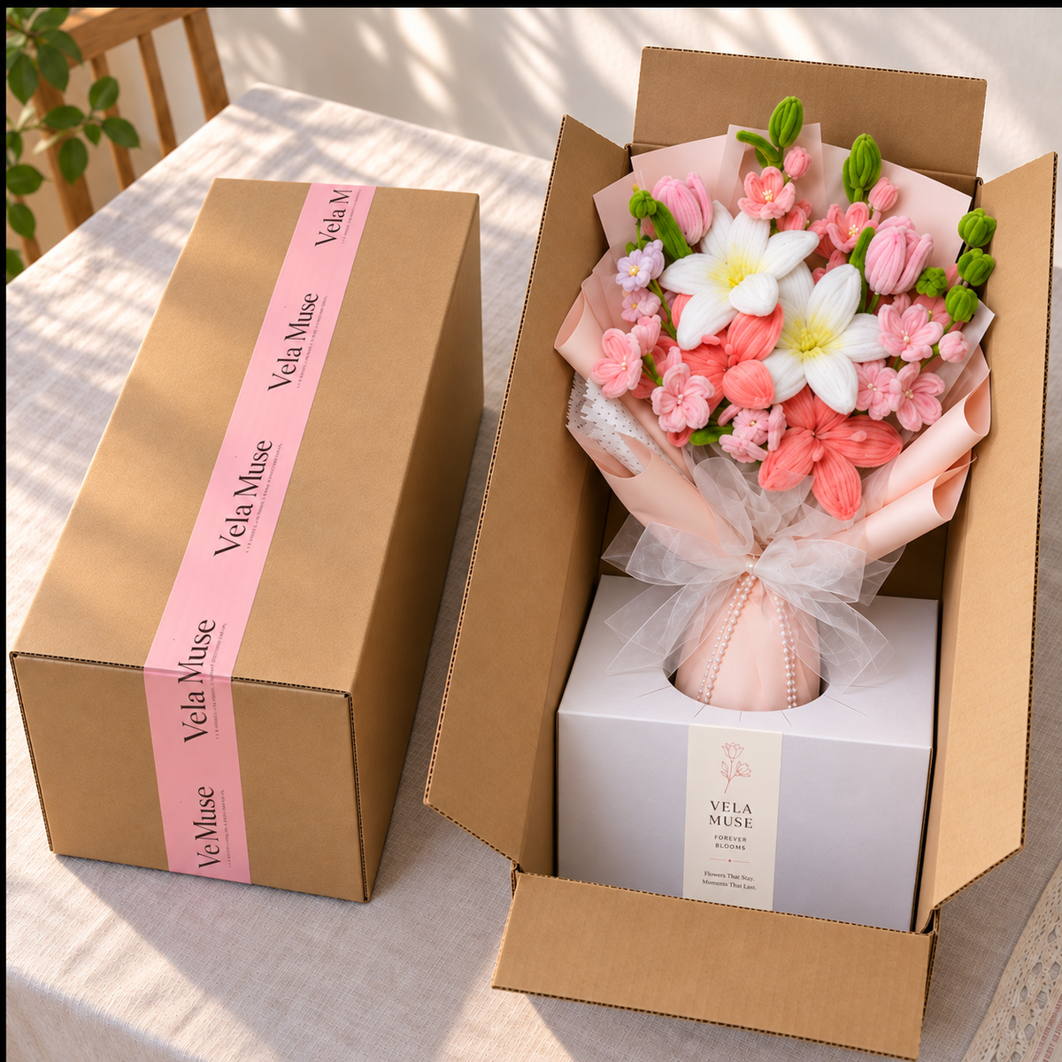 Vela Muse finished bouquet secured in its ordinary protective shipping box with branded pink tape and fitted inner support.