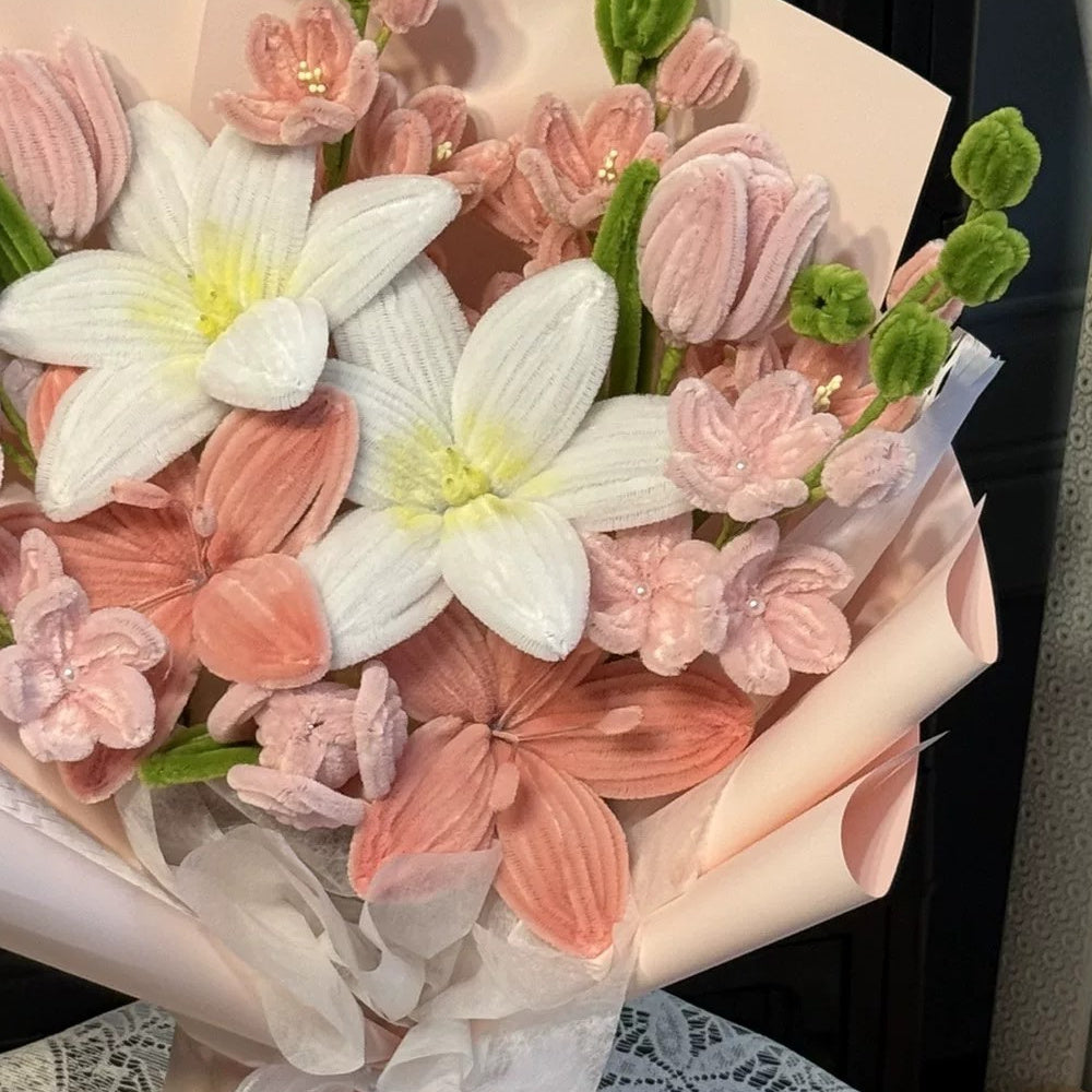 Detail of the Blush Romance bouquet showing textured white, coral and pink chenille flowers and pale pink wrapping.