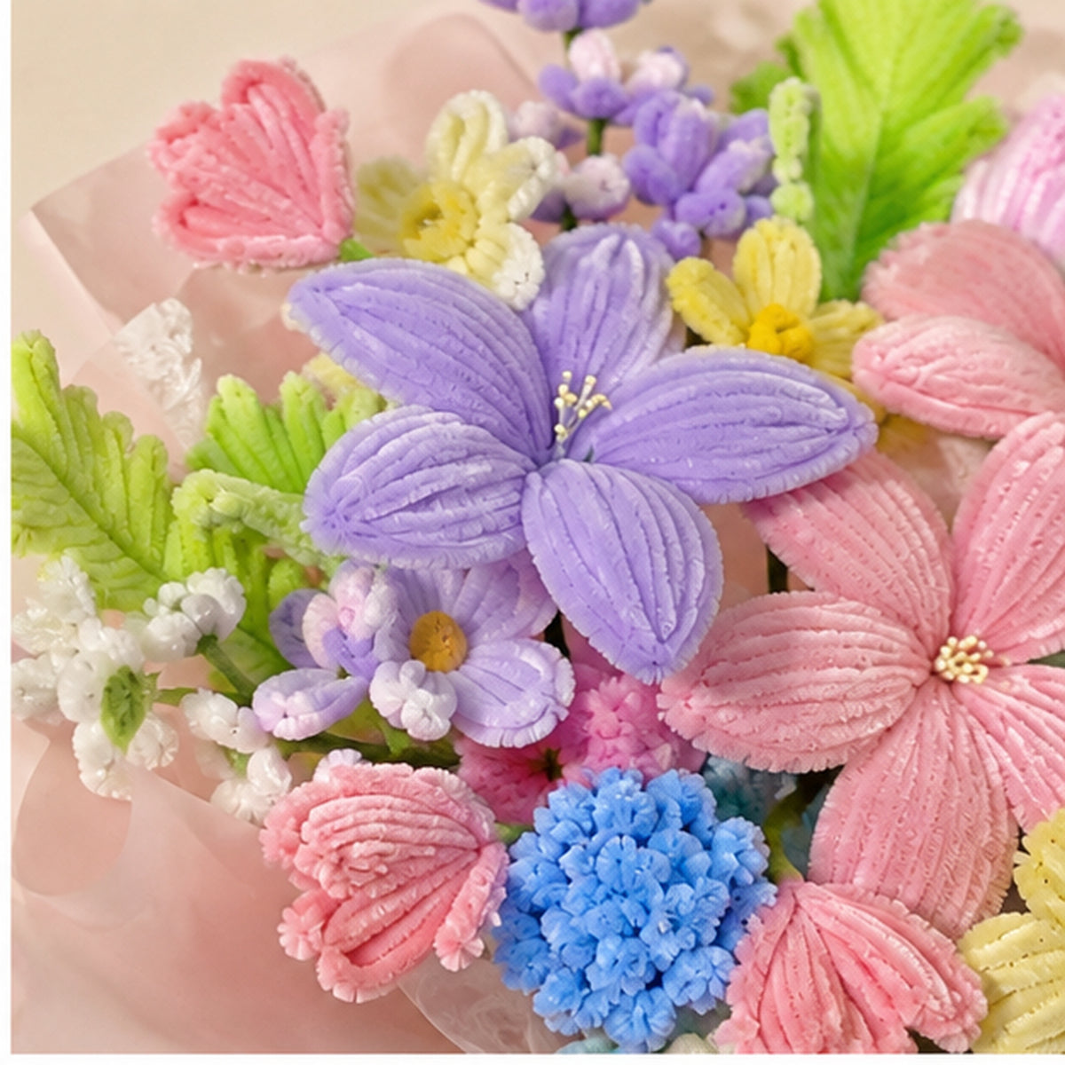 Close-up of the Modern Orchid handmade chenille bouquet, showing textured lavender, pink, yellow and blue flowers.