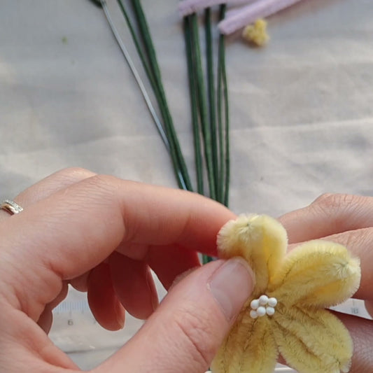 Small yellow chenille flower shown in the assembly lesson